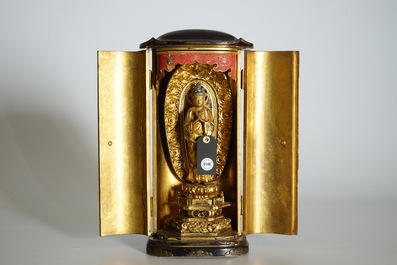 A Japanese lacquered and gilt wood "Zushi" shrine with a standing Buddha on a lotus throne, Edo, 17/18th C.